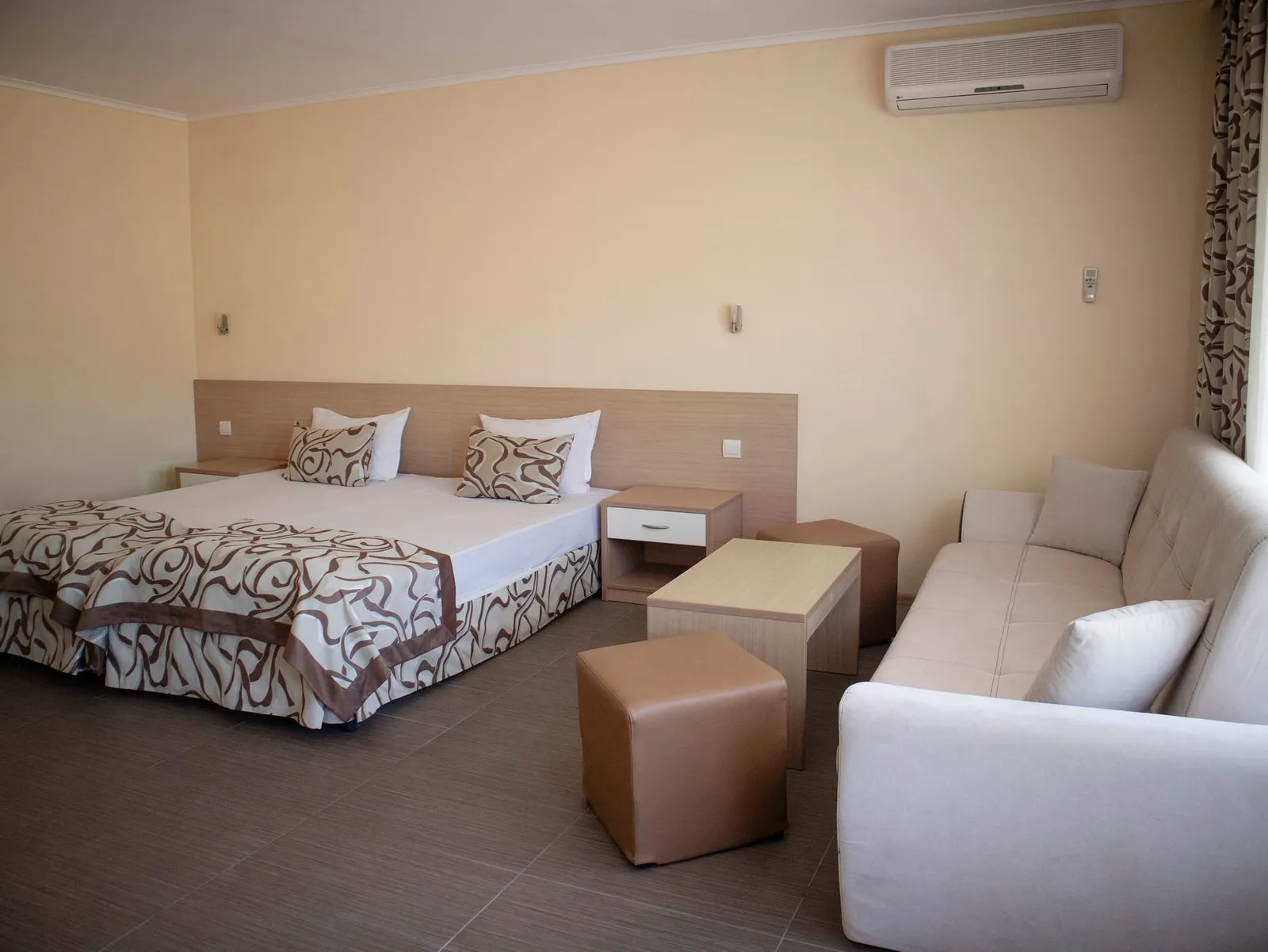 Family Room: double bed, nightstand and sofa with a pouf