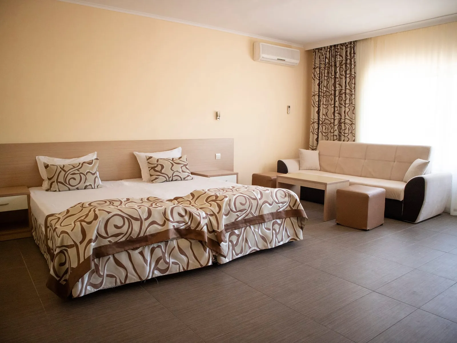 Family Room: double bed, sofa and coffee table by the window