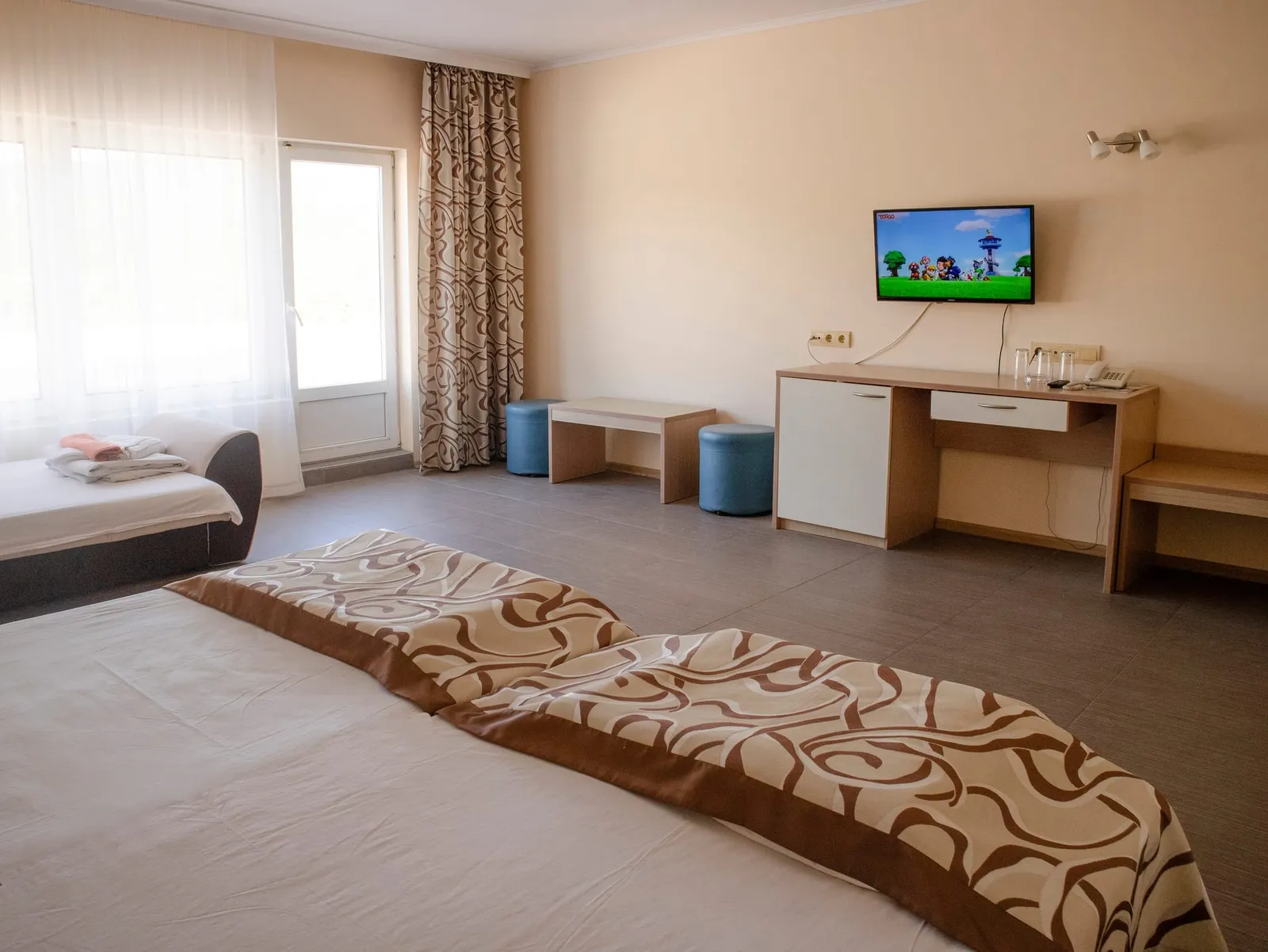 Family Room: desk with TV and the beds in the room