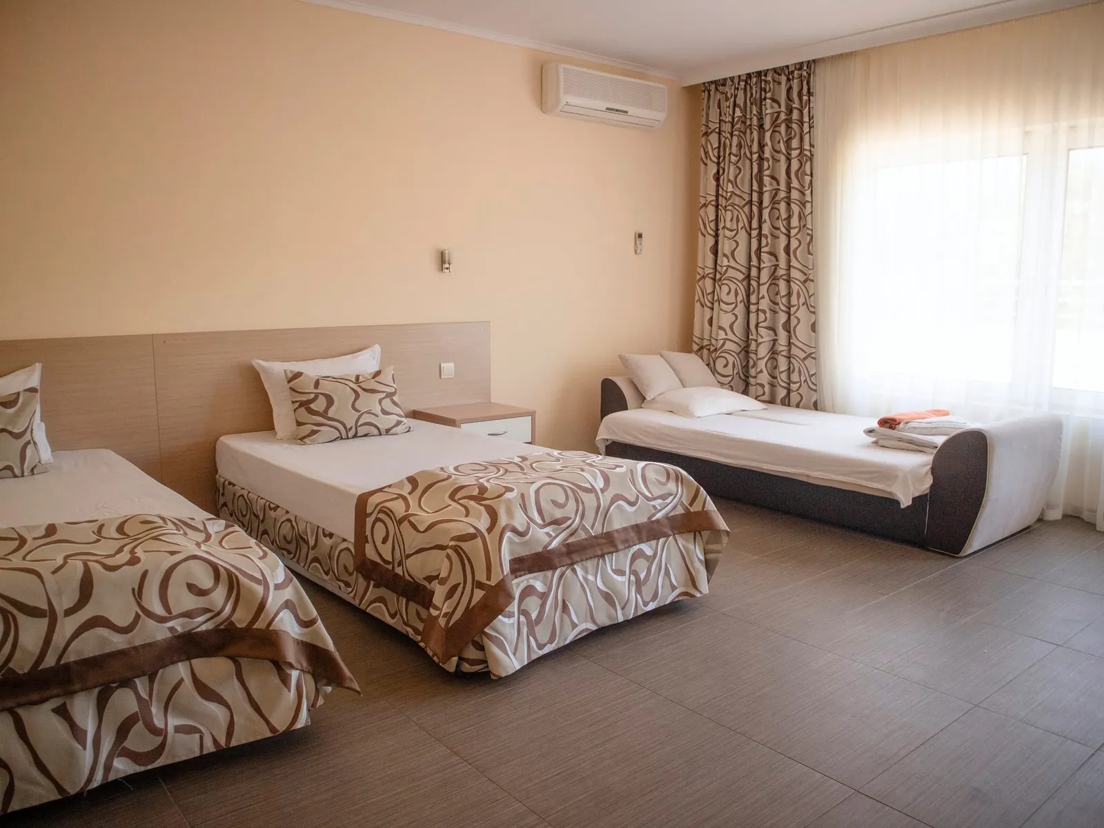 Family Room: spacious room with beds by the window and the balcony