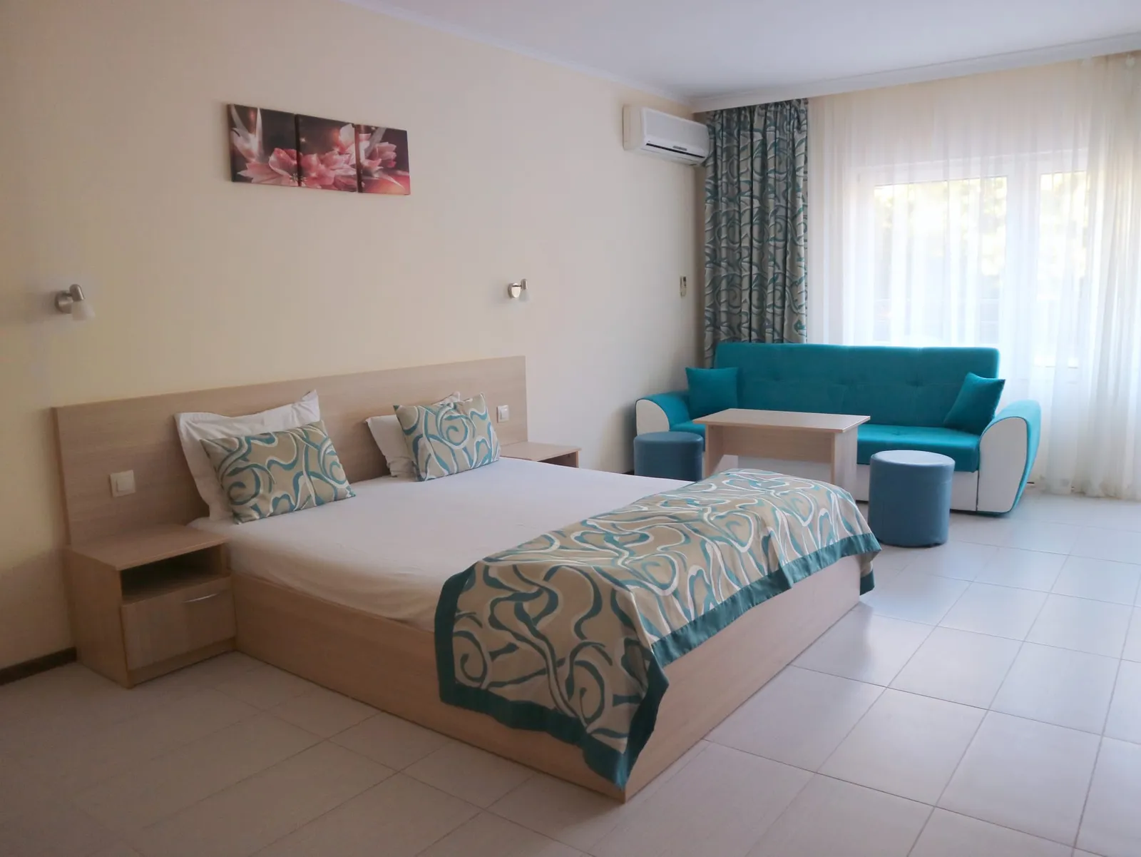 Family Room: double bed with headboard and a turquoise sofa